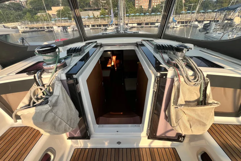 Wind Walker Yacht Photos Pics Beneteau Oceanis 41 sailboat cockpit with open hatch, ropes, and winches, docked at marina.