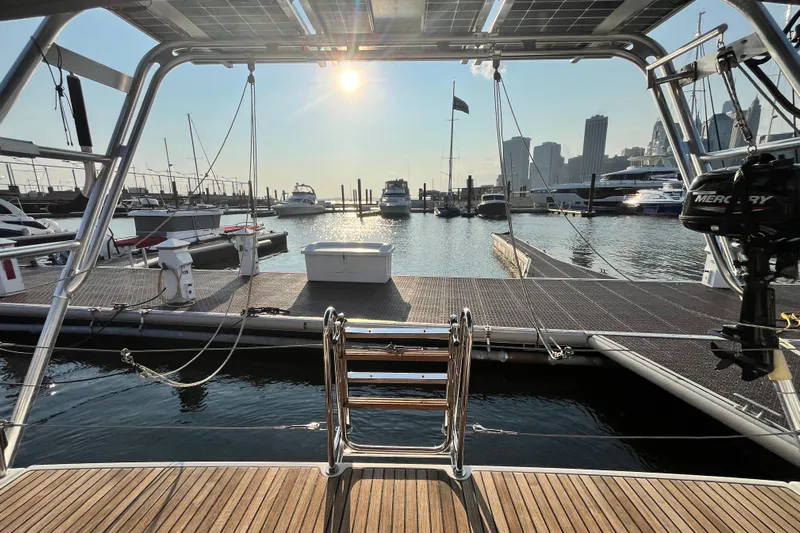 Wind Walker Yacht Photos Pics Beneteau Oceanis 41 sailboat docked at marina, city skyline in background, sunny day.