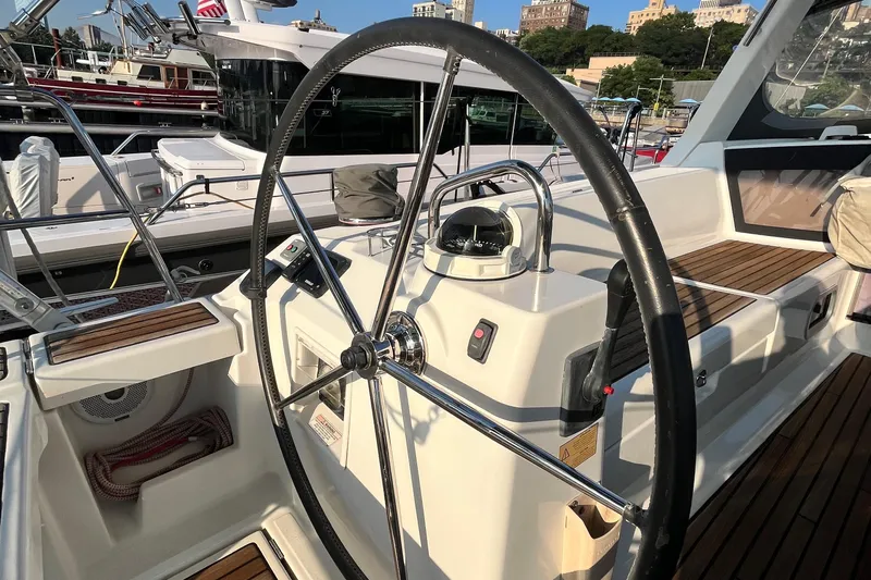 Wind Walker Yacht Photos Pics Steering wheel of a 2013 Beneteau Oceanis 41 sailboat, docked in a marina.