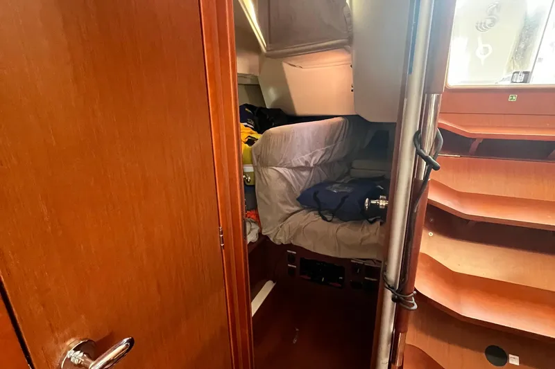 Wind Walker Yacht Photos Pics Interior cabin of 2013 Beneteau Oceanis 41 sailboat with wooden finishes and cozy sleeping area.
