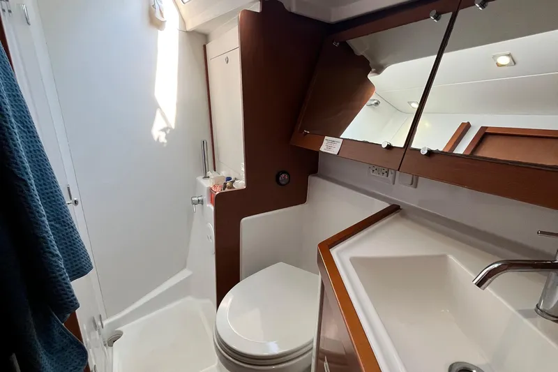 Wind Walker Yacht Photos Pics Bathroom interior of 2013 Beneteau Oceanis 41 yacht, featuring sink, toilet, and mirror.