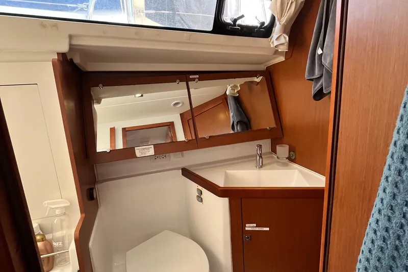 Wind Walker Yacht Photos Pics Beneteau Oceanis 41 bathroom interior, featuring a mirror, sink, and wooden cabinetry, 2013 model.