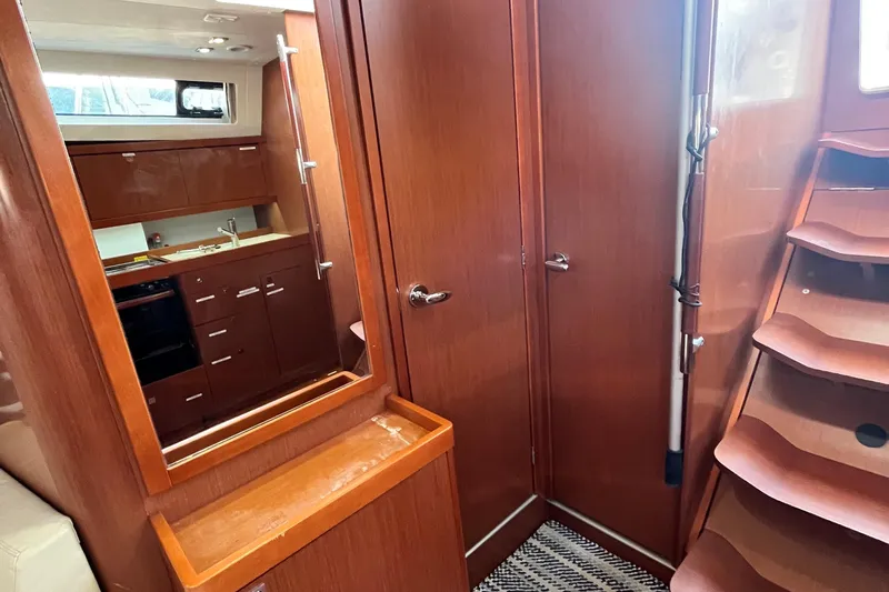 Wind Walker Yacht Photos Pics Interior of 2013 Beneteau Oceanis 41 yacht with wooden cabinetry and staircase.