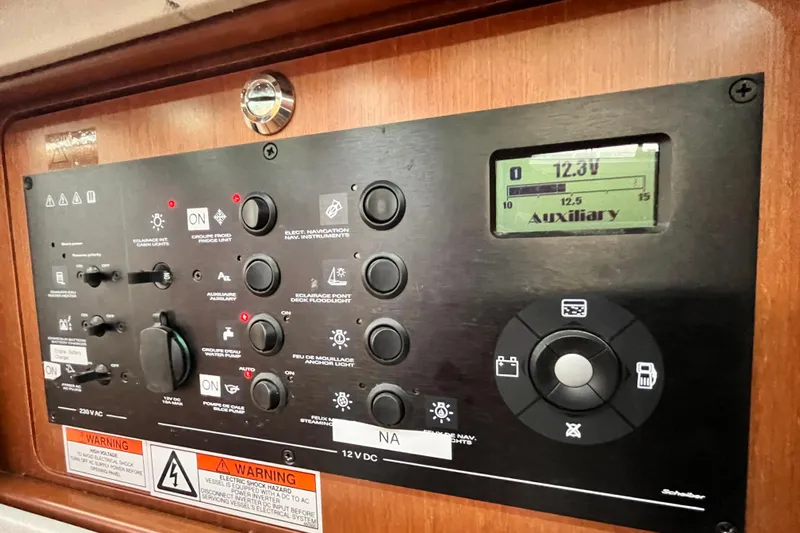 Wind Walker Yacht Photos Pics Control panel of a 2013 Beneteau Oceanis 41 sailboat, displaying voltage and switches.