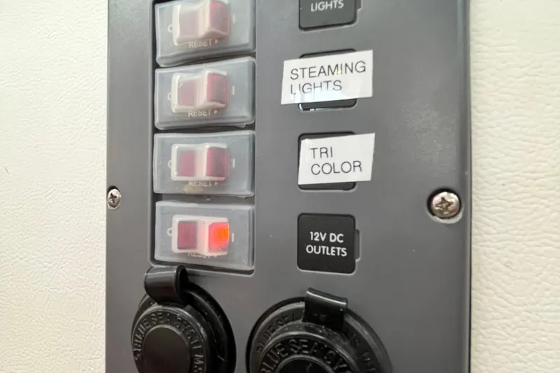 Wind Walker Yacht Photos Pics Control panel of a 2013 Beneteau Oceanis 41 sailboat with labeled switches and outlets.