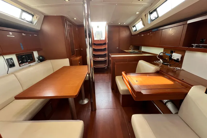 Wind Walker Yacht Photos Pics 2013 Beneteau Oceanis 41 yacht interior with wood finish and seating area.