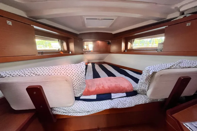 Wind Walker Yacht Photos Pics Cozy cabin interior of 2013 Beneteau Oceanis 41 sailboat with striped bedding.