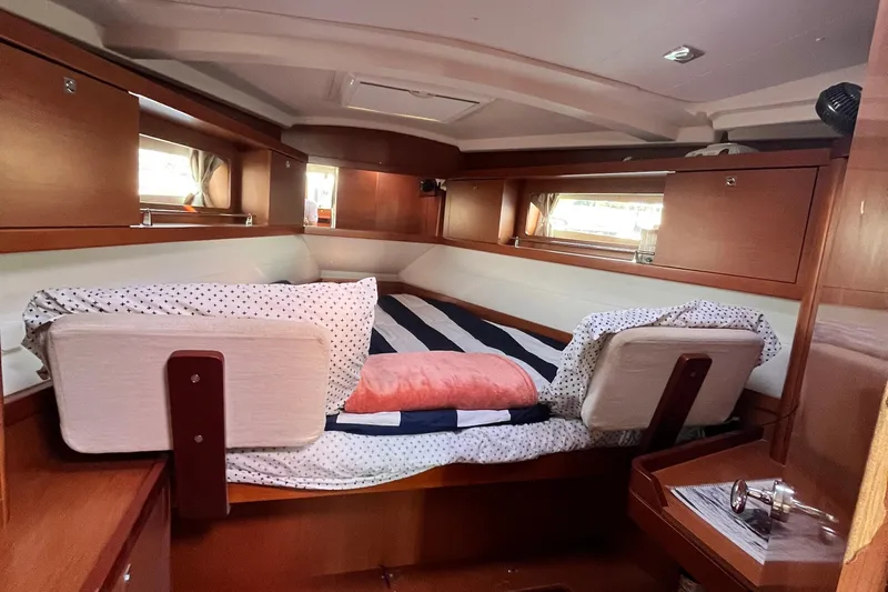 Wind Walker Yacht Photos Pics Cozy cabin interior of 2013 Beneteau Oceanis 41 sailboat with striped bedding.