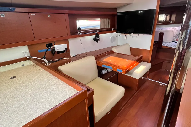 Wind Walker Yacht Photos Pics Interior of 2013 Beneteau Oceanis 41 yacht with seating, table, and TV.