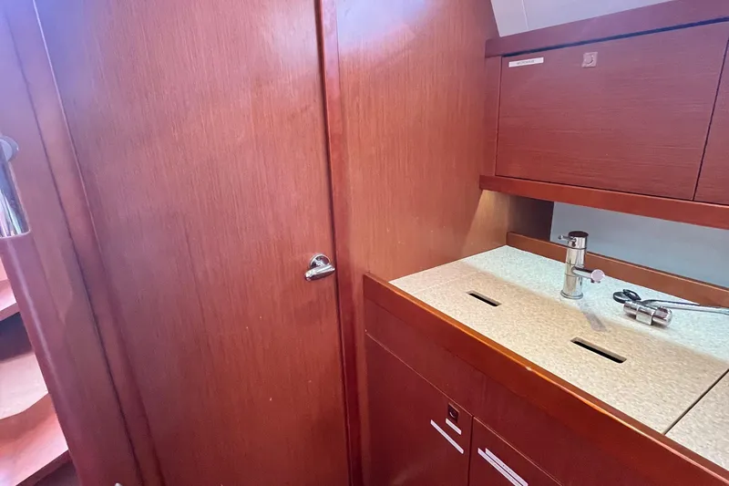 Wind Walker Yacht Photos Pics Interior of 2013 Beneteau Oceanis 41 yacht, featuring wooden cabinetry and a compact sink area.