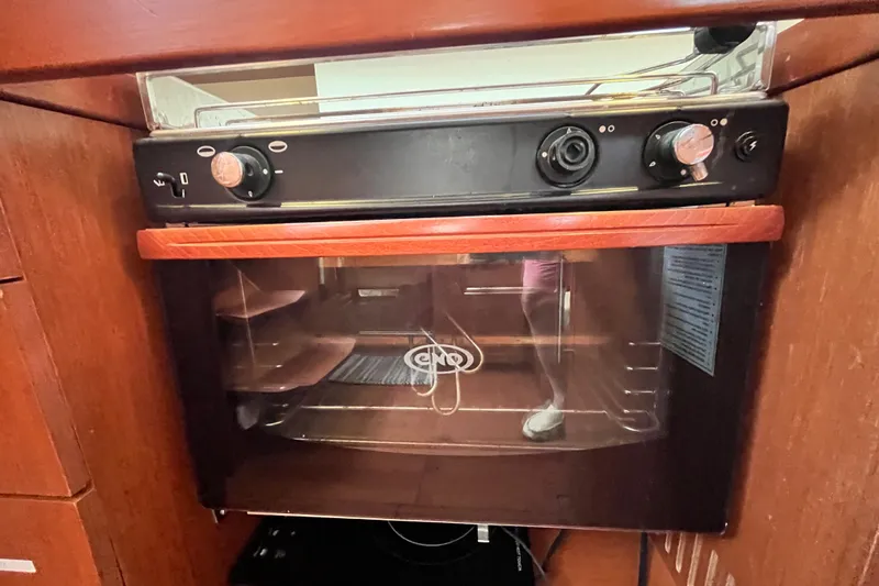 Wind Walker Yacht Photos Pics Oven in 2013 Beneteau Oceanis 41 yacht kitchen, featuring wooden cabinetry.