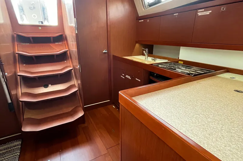Wind Walker Yacht Photos Pics Interior of 2013 Beneteau Oceanis 41 yacht, featuring wooden cabinetry and compact kitchen area.