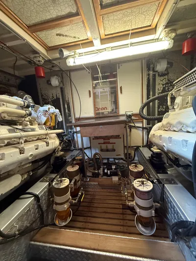 Aramis II Yacht Photos Pics Engine room of a 1990 Grand Banks 49 yacht, featuring dual engines and mechanical equipment.
