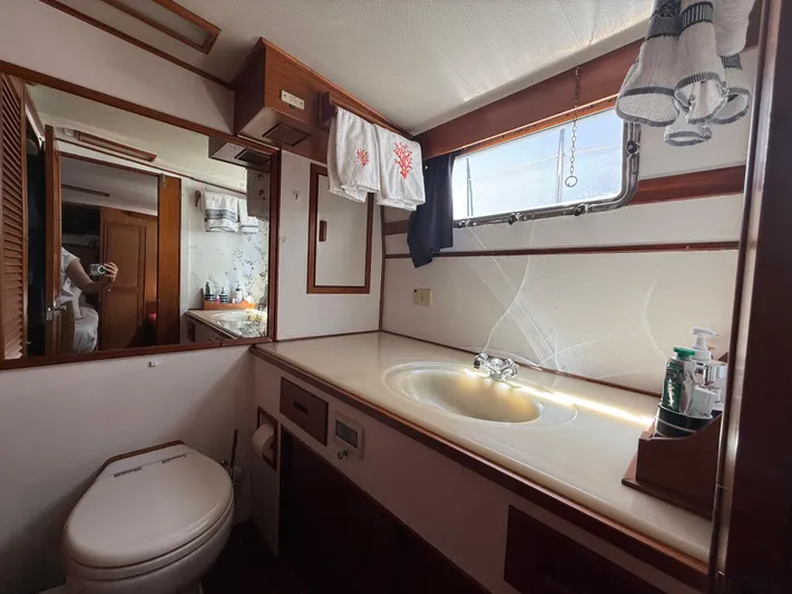 Aramis II Yacht Photos Pics Bathroom interior of a 1990 Grand Banks 49 yacht with sink and toilet.