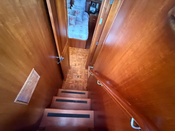 Aramis II Yacht Photos Pics Wooden staircase leading to a cozy cabin interior on a 1990 Grand Banks 49 yacht.