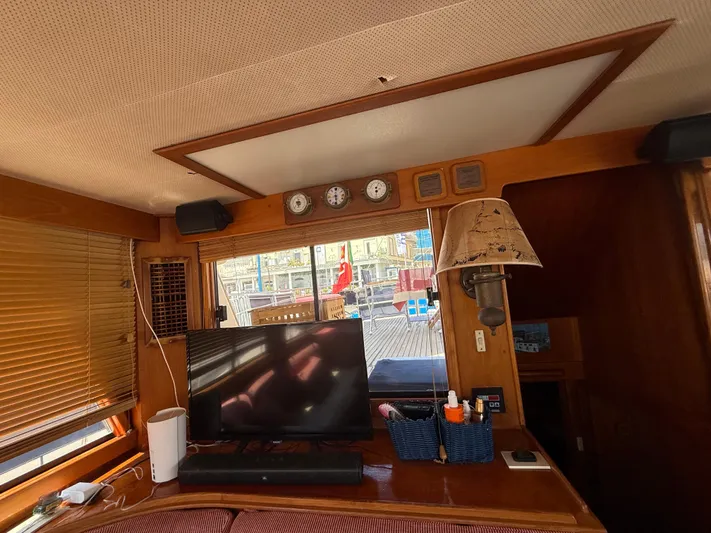 Aramis II Yacht Photos Pics Interior of a 1990 Grand Banks 49 yacht with TV, lamp, and nautical decor.