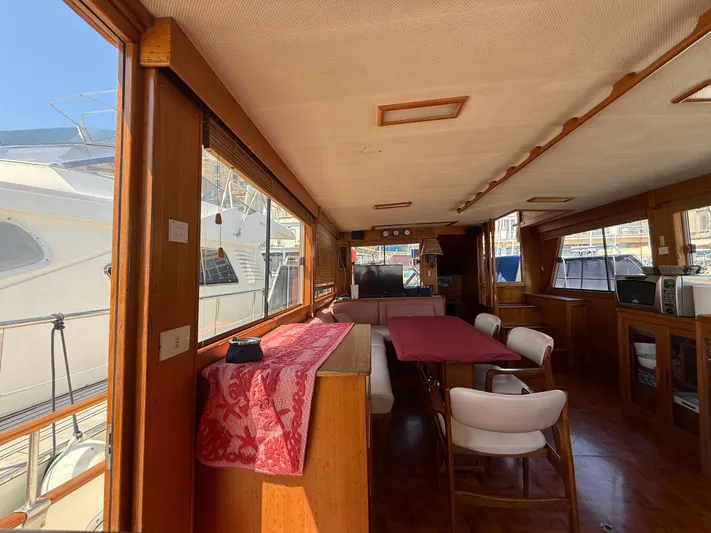 Aramis II Yacht Photos Pics Interior of a 1990 Grand Banks 49 yacht with dining area and wooden furnishings.