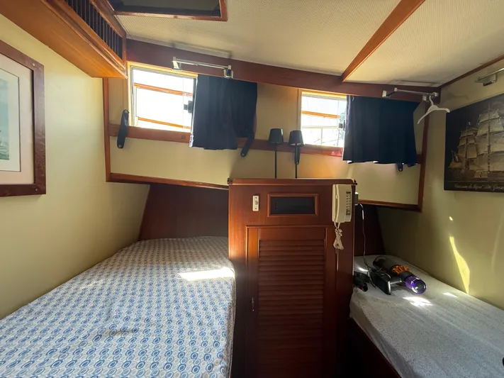 Aramis II Yacht Photos Pics Cozy cabin interior of 1990 Grand Banks 49 yacht with twin beds and nautical decor.