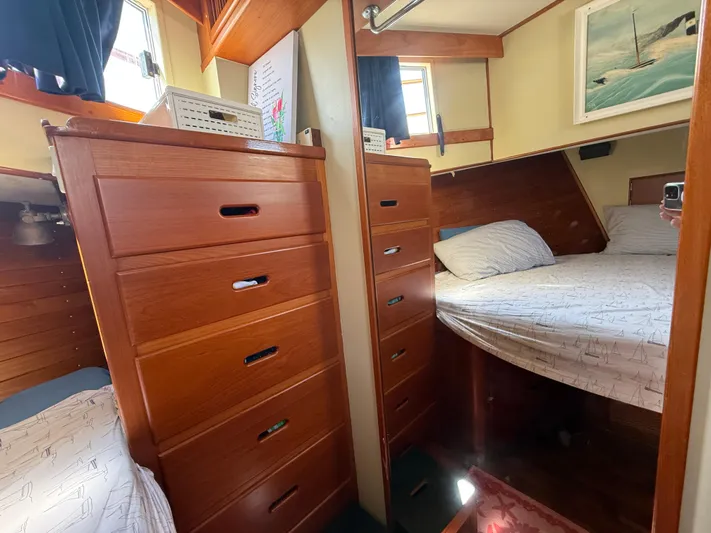 Aramis II Yacht Photos Pics Cozy cabin interior of 1990 Grand Banks 49 yacht with wooden drawers and bed.