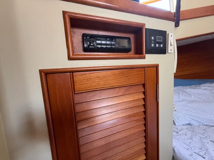 Aramis II Yacht Photos Pics 1990 Grand Banks 49 interior with wood paneling and Panasonic stereo system.