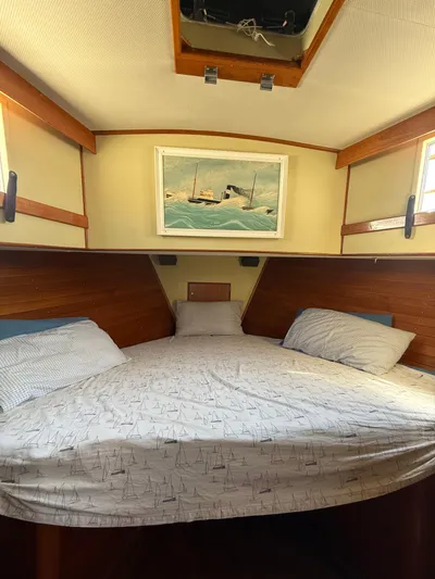 Aramis II Yacht Photos Pics Cozy cabin interior of 1990 Grand Banks 49 yacht with nautical-themed bedding.