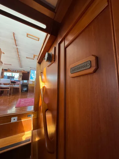 Aramis II Yacht Photos Pics Interior of 1990 Grand Banks 49 yacht showing wooden bathroom door and living area.