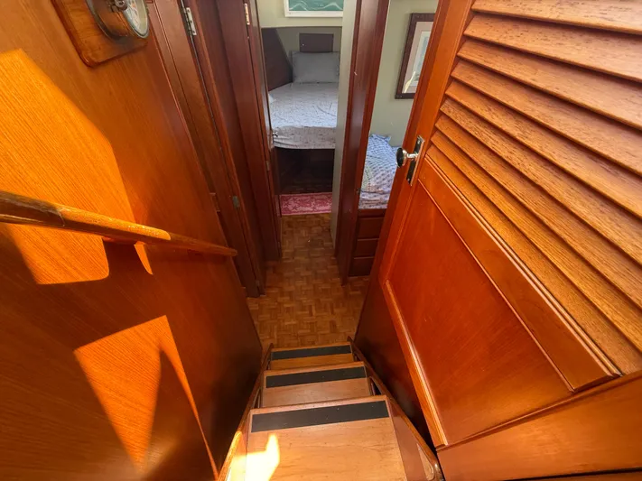 Aramis II Yacht Photos Pics Interior of 1990 Grand Banks 49 yacht, featuring wooden stairs and cozy cabin.