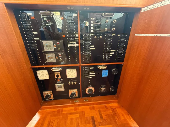 Aramis II Yacht Photos Pics Electrical control panel on a 1990 Grand Banks 49 yacht, featuring gauges and switches.