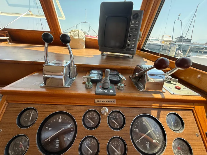 Aramis II Yacht Photos Pics Control panel of a 1990 Grand Banks 49 yacht with gauges and levers.