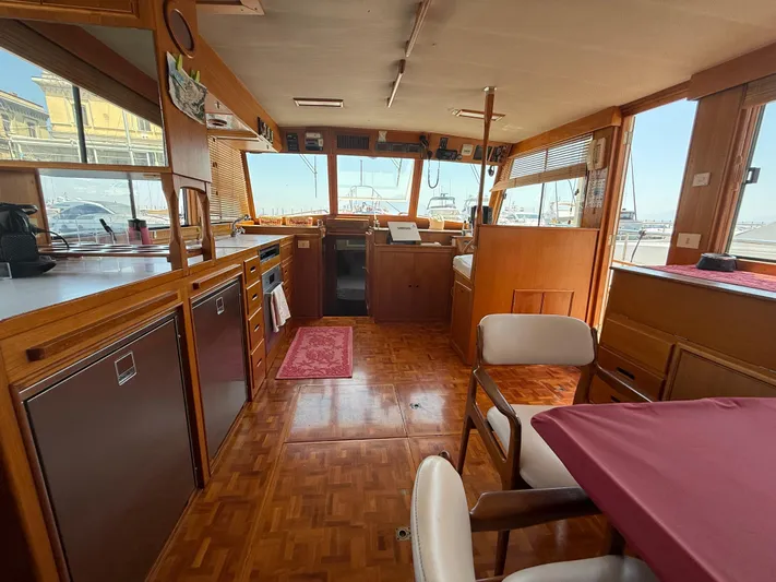 Aramis II Yacht Photos Pics Interior of a 1990 Grand Banks 49 yacht with wooden furnishings and dining area.