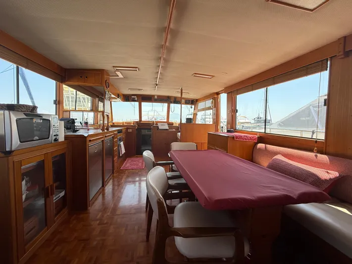 Aramis II Yacht Photos Pics Interior of a 1990 Grand Banks 49 yacht with dining area and kitchen.