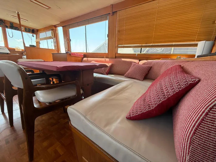 Aramis II Yacht Photos Pics Interior of 1990 Grand Banks 49 yacht with cozy seating and wooden accents.