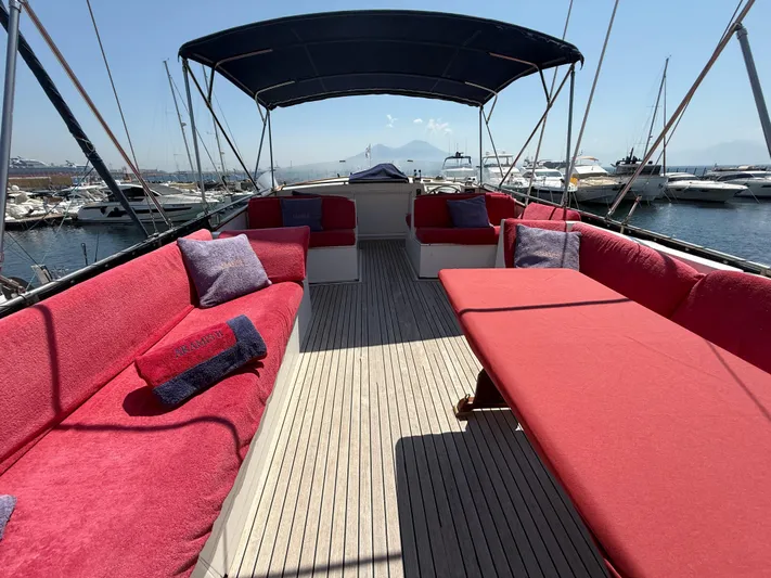 Aramis II Yacht Photos Pics Spacious deck of 1990 Grand Banks 49 yacht with red seating and marina view.