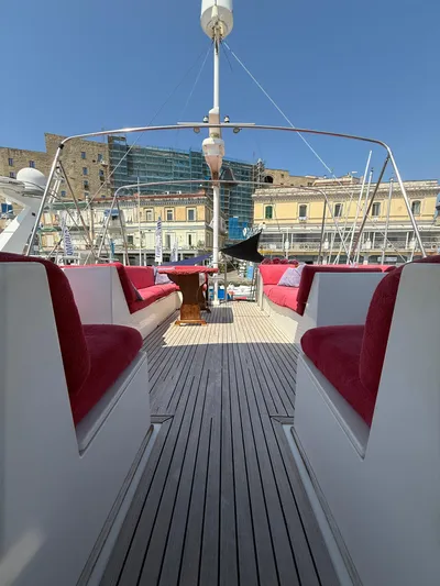 Aramis II Yacht Photos Pics Deck view of 1990 Grand Banks 49 yacht with red seating and wooden flooring.