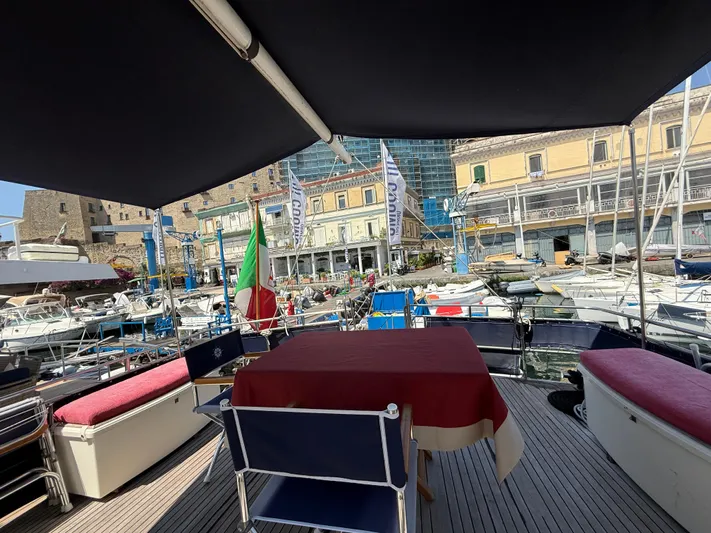 Aramis II Yacht Photos Pics Deck view from a 1990 Grand Banks 49 yacht, overlooking a marina with boats and buildings.