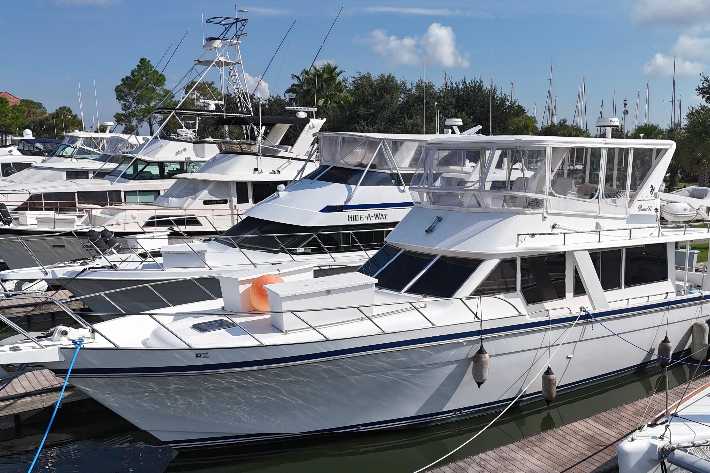 Docked Prima 52 Seahorse yacht, 2001 model, in a marina with other boats.