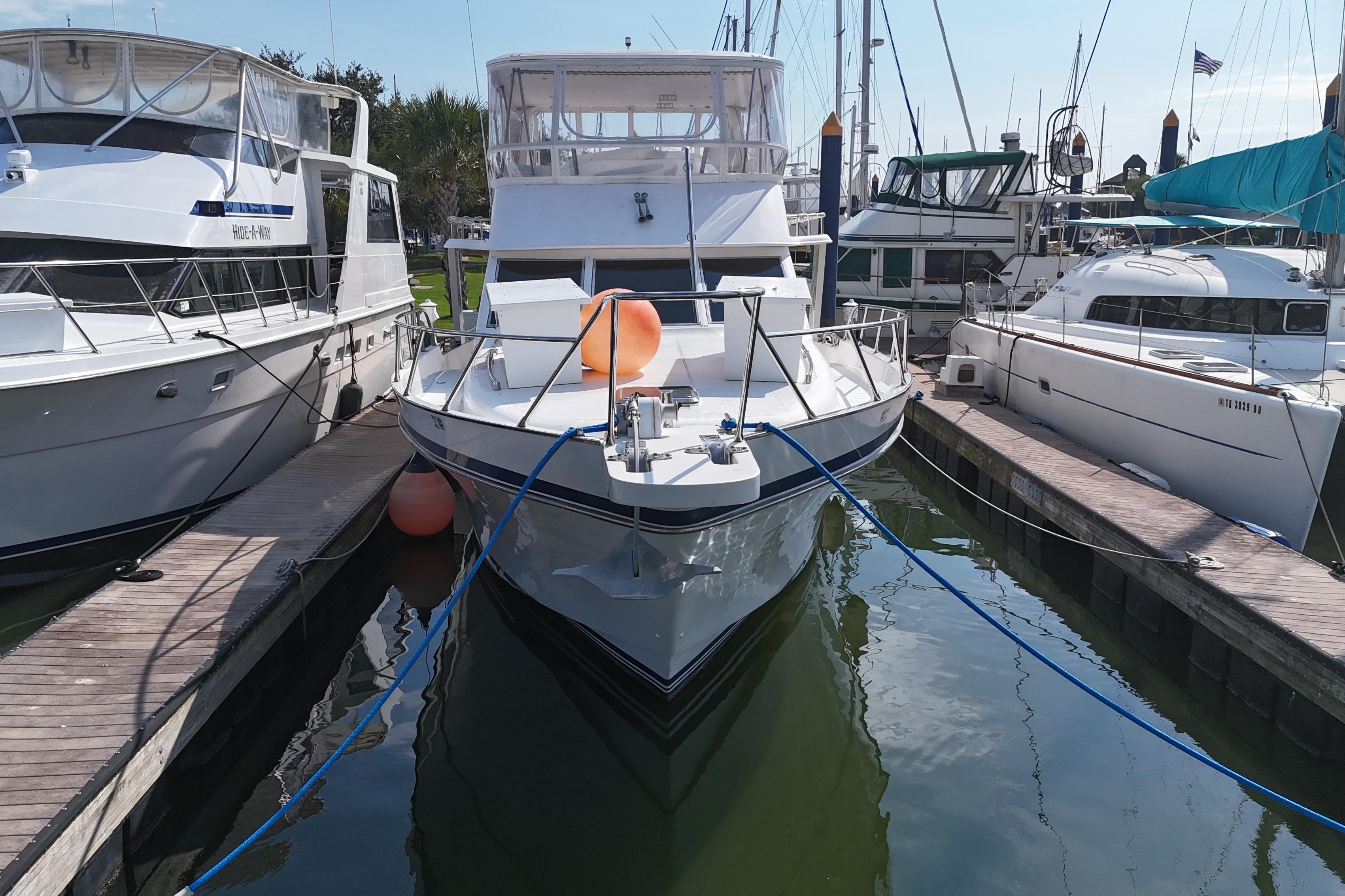 Docked Prima 52 Seahorse yacht, 2001 model, surrounded by other boats in a marina.