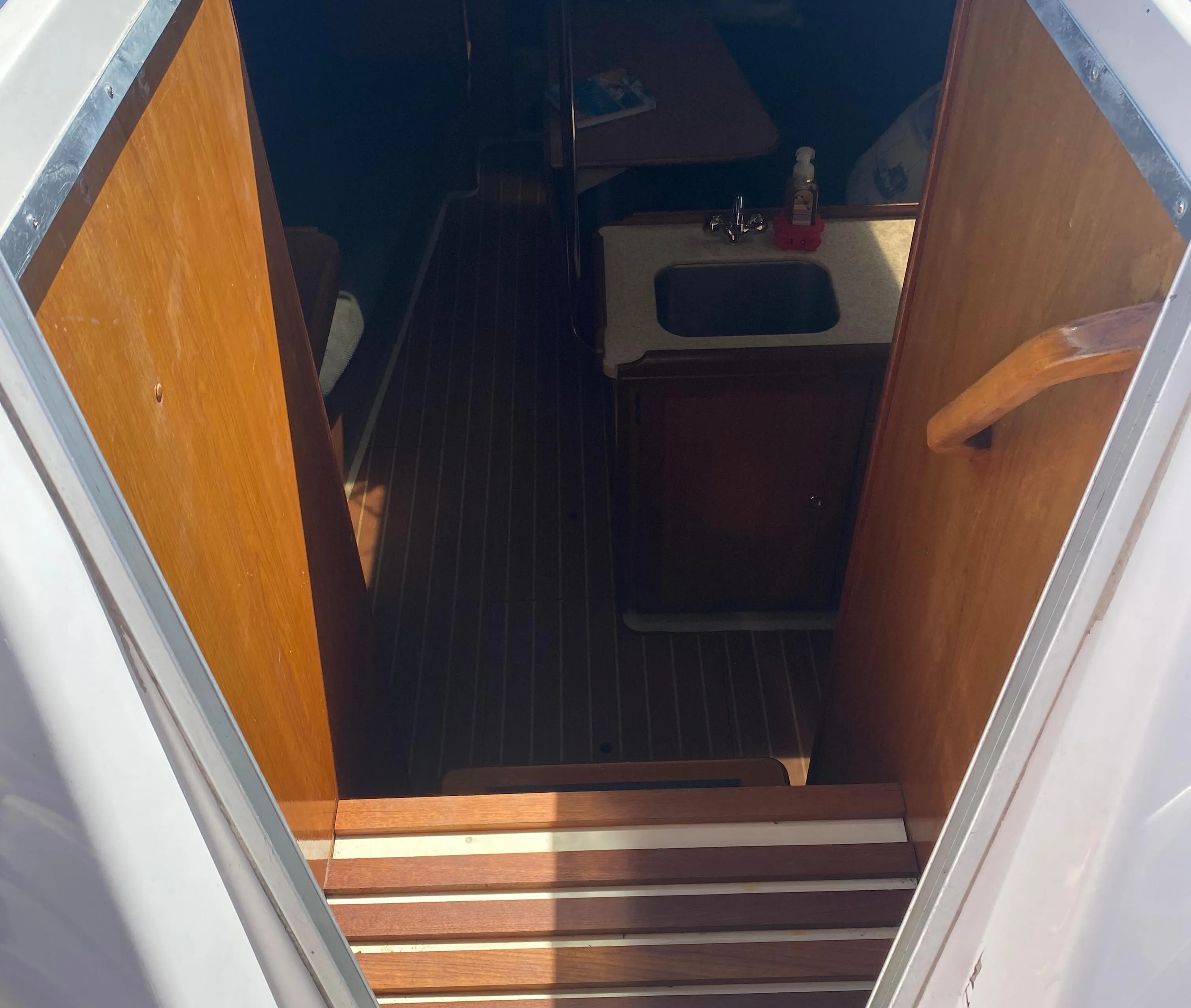 Interior view of 2009 Hunter 31-2 sailboat cabin with wooden finishes.