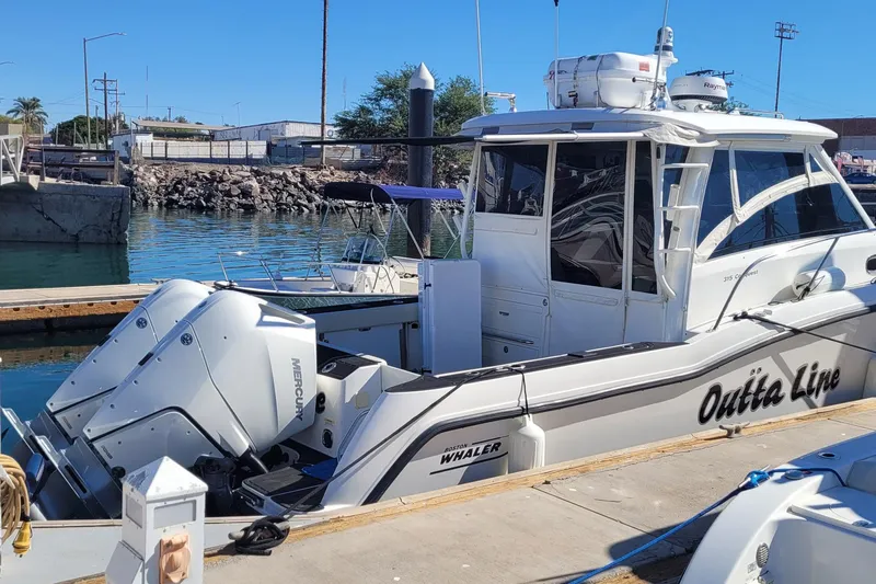 Outta Line Yacht Photos Pics 2017 Boston Whaler 315 Conquest docked with twin Mercury engines.