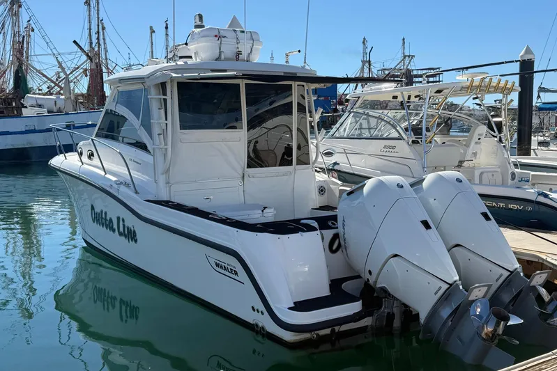Outta Line Yacht Photos Pics 2017 Boston Whaler 315 Conquest boat docked with twin outboard engines.