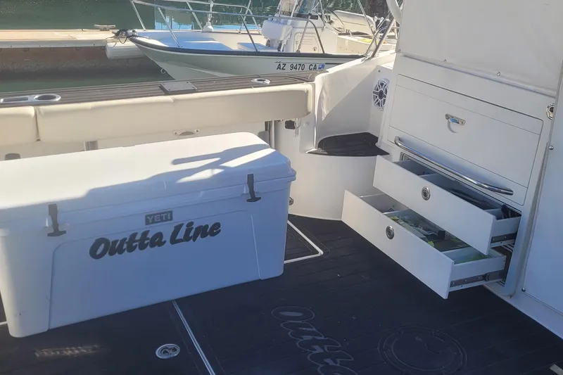 Outta Line Yacht Photos Pics 2017 Boston Whaler 315 Conquest boat interior with Yeti cooler and storage drawers.