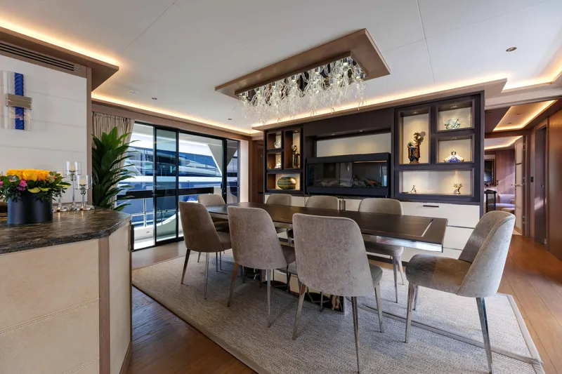 Heliophilia Yacht Photos Pics Luxurious interior of 2024 Sirena 88 yacht with elegant dining area and modern decor.