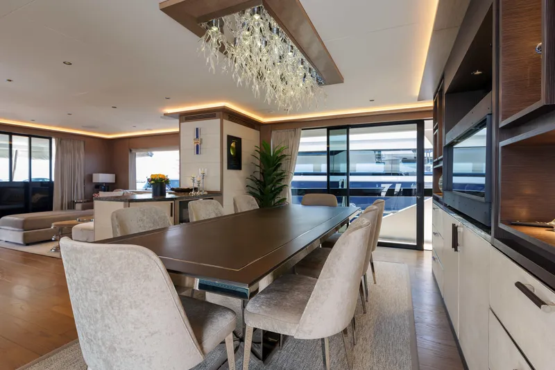 Heliophilia Yacht Photos Pics Luxurious interior of 2024 Sirena 88 yacht with elegant dining area and modern decor.