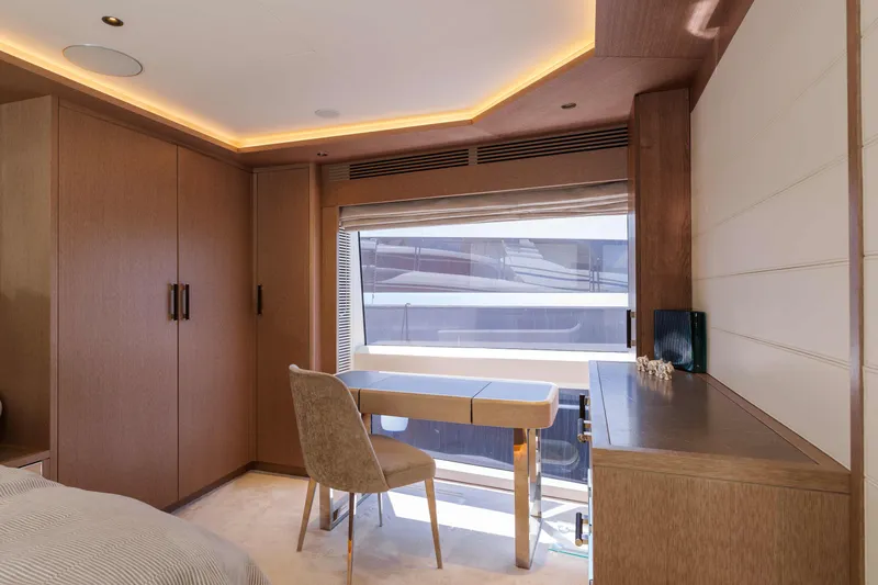 Heliophilia Yacht Photos Pics Luxurious interior of 2024 Sirena 88 yacht with modern desk and window view.