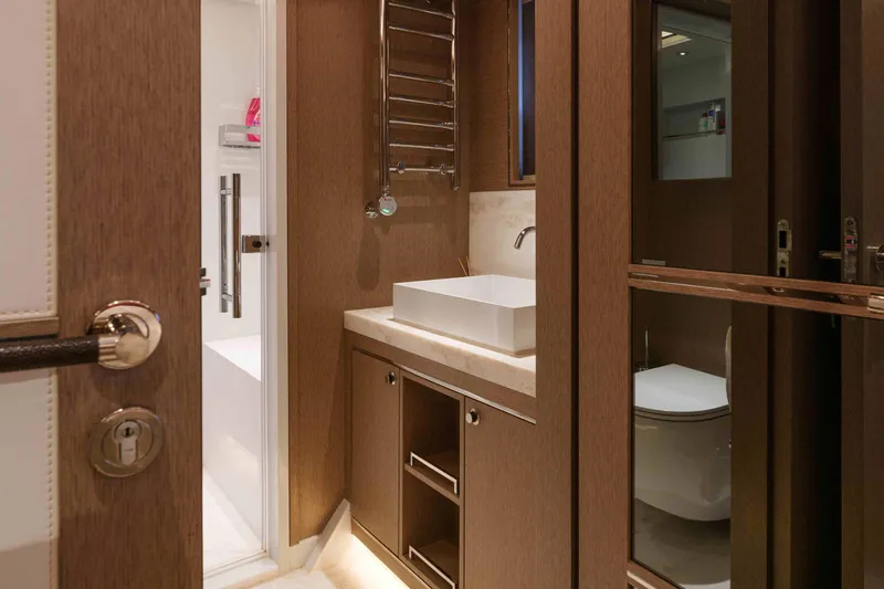 Heliophilia Yacht Photos Pics Luxurious bathroom interior of 2024 Sirena 88 yacht, featuring modern fixtures and elegant wood finishes.