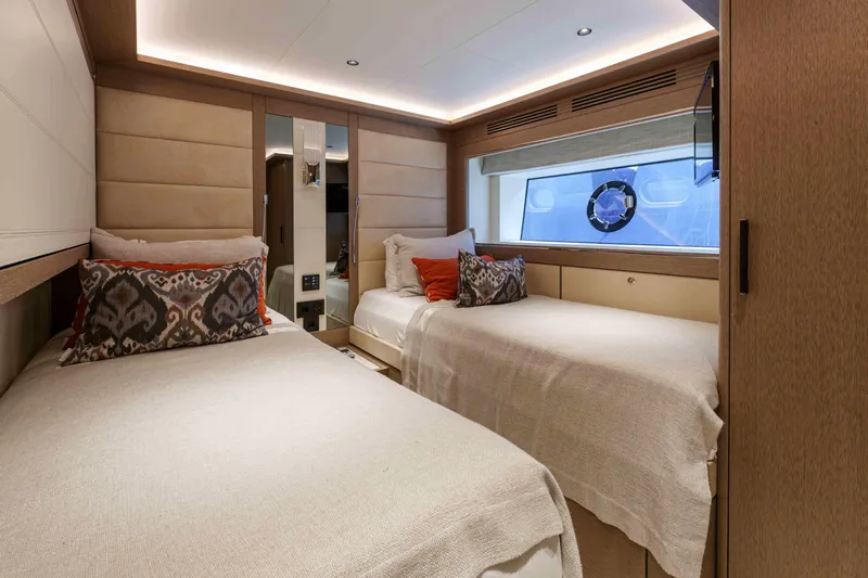 Heliophilia Yacht Photos Pics Luxurious twin bedroom in 2024 Sirena 88 yacht with modern decor and ocean view.