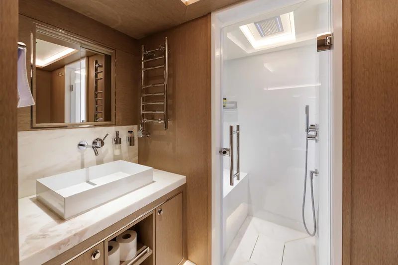 Heliophilia Yacht Photos Pics Luxurious bathroom in 2024 Sirena 88 yacht with modern fixtures and elegant design.