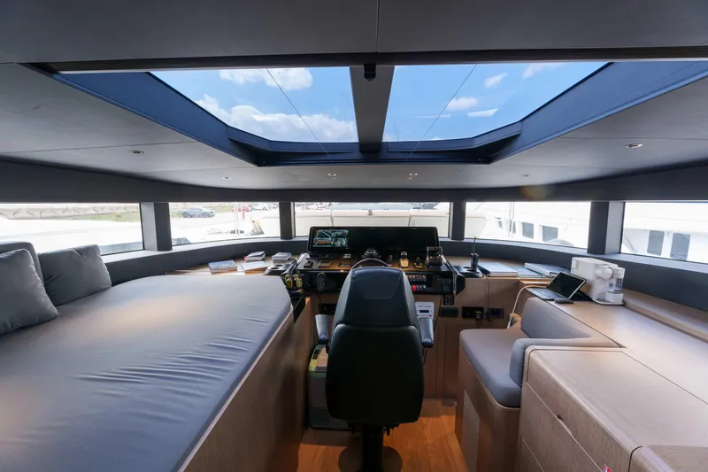 Heliophilia Yacht Photos Pics Luxurious interior of 2024 Sirena 88 yacht with panoramic windows and modern helm.