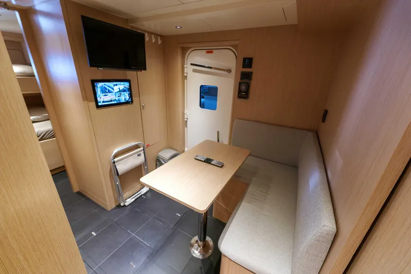 Heliophilia Yacht Photos Pics 2024 Sirena 88 yacht interior with cozy seating, table, and modern amenities.