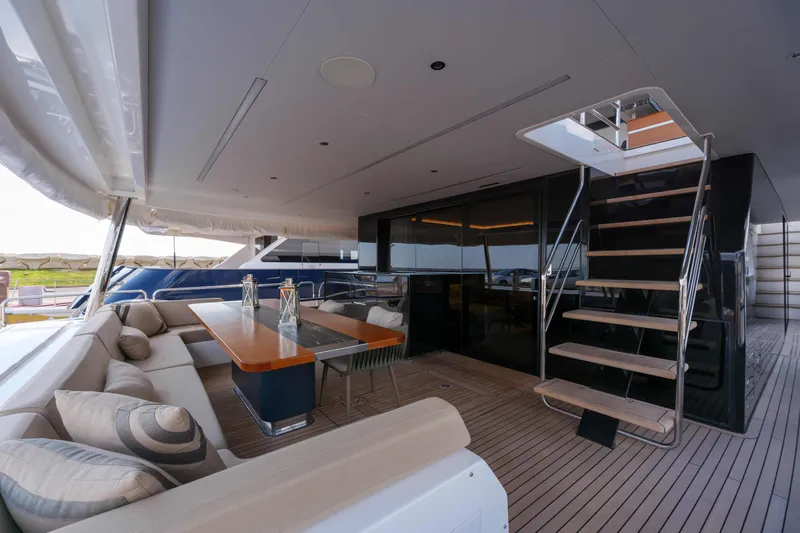 Heliophilia Yacht Photos Pics Luxurious 2024 Sirena 88 yacht deck with elegant seating and modern staircase.